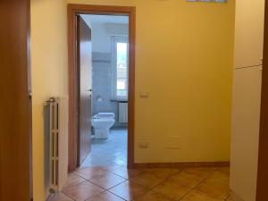 a bathroom with a toilet and a yellow wall at Fior Di Sambuco in Broni