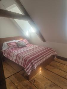a bedroom with a bed in an attic at Om chalet 1 avec spa face au fleuve in Saint-Jean +14 photos