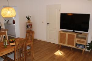a living room with a flat screen tv on a stand at Ferienwohnung Annette Mieth in Weitenhagen
