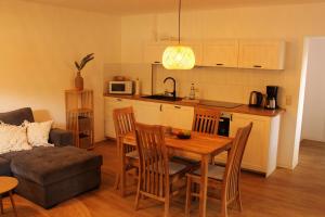 a kitchen and living room with a table and chairs at Ferienwohnung Annette Mieth in Weitenhagen
