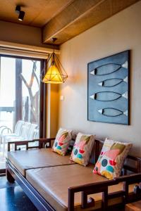 a living room with a couch and a large window at Let go see the Dolphin Samroiyot in Baanphakrimlay  +18 photos