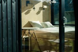 a room with a bed and a table and a window at Cabin stay with optional Donkey Picnic Experience in Hallau