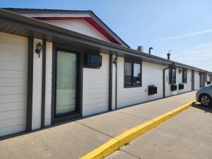 a building with a car parked in front of it at Super 8 by Wyndham Valentine NE in Valentine