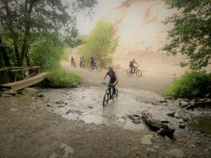 a group of people riding bikes on a dirt road at Lovely Duplex Axime with beautiful hill views - Malmedy in Malmedy