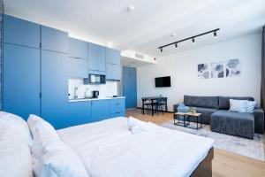 a living room with a bed and a couch at Azure Apartman Miskolc in Miskolc