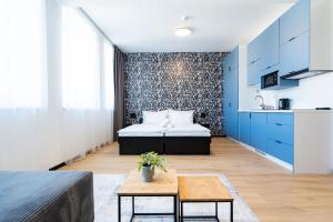 a bedroom with a bed and a table in a room at Azure Apartman Miskolc in Miskolc