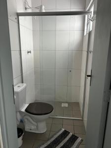 a small bathroom with a toilet and a shower at HL Hotel in Pelotas