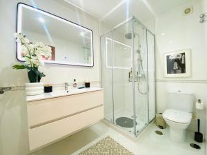 a bathroom with a shower and a sink and a toilet at Colinas do Cruzeiro Residence Odivelas in Odivelas +38 photos