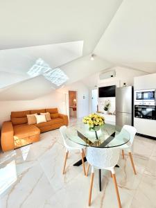 a living room with a glass table and a couch at Refúgio do Vale Verde in Ponta do Sol +13 photos
