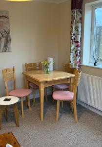 a dining room table with chairs and a wooden table at The Wright Place To stay in East Harling