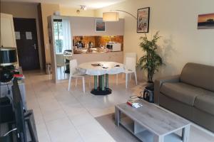 a living room with a couch and a table at 100 m from the beach prime location in Arcachon