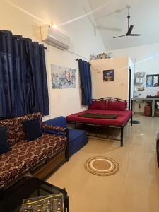 a living room with a couch and a table at The Wilderness Studio! in Anjuna