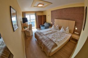 a bedroom with a large bed in a room at Pension Carinthia in Unterburg am Klopeiner See
