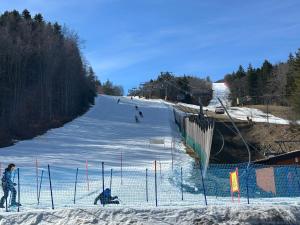 a group of people skiing down a snow covered slope at Discovering Apartment Pulicchio in Abetone