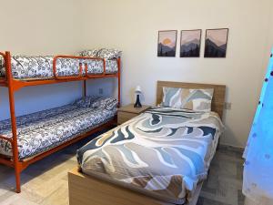 a bedroom with two bunk beds and a bed at Discovering Apartment Pulicchio in Abetone