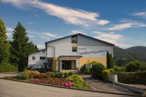 a building with a car parked in front of it at Pension Carinthia in Unterburg am Klopeiner See +7 photos