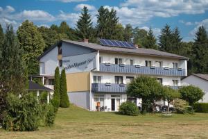 a house with solar panels on the roof at Pension Carinthia in Unterburg am Klopeiner See