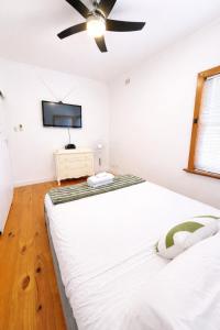 a bedroom with two beds and a ceiling fan at 2BR Beachfront Escape in Largs North in Semaphore