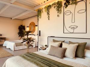 a bedroom with a large bed with plants on the wall at Villa de Diseño con Piscina Privada in Pastores