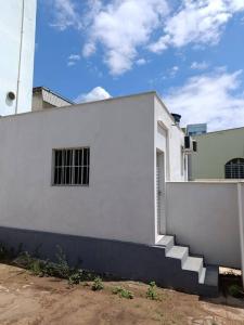 a white building with stairs on the side of it at Apart hotel in Três Marias
