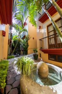 a courtyard with a fountain in front of a building at Hotel Casa Conzatti in Oaxaca City