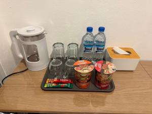 a tray with bottles of water and cups on a table at ดิโอโซน THE Ozone in Ban Bung Sanan