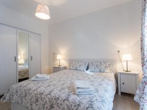 a bedroom with a bed with two towels on it at Apartments Urban Porec in Poreč