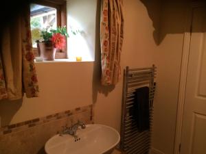 a bathroom with a sink and a window at Woodmill Farm Apartment in Alvington +37 photos