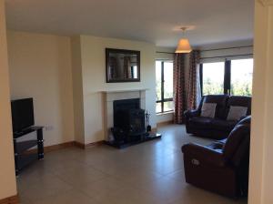 a living room with a couch and a fireplace at Kilmore Quay Castleview II in Kilmore Quay