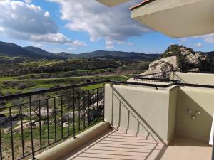 a balcony with a view of the mountains at EFThea Valley in Skála Sikiás