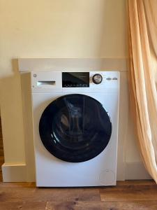 a white washing machine in a room with a window at Centrally Located With Lake Views in Burlington