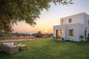 a villa with a view of the sunset at Exclusive Olive & Herb Villa, Mountain to Sea Views, Rhodes in Afantou