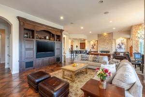 a living room with a couch and a tv at The Fourteen at PGA West in La Quinta
