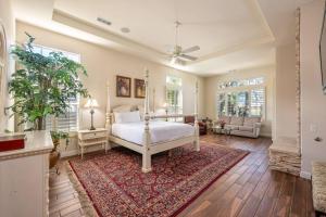 a bedroom with a white bed and a rug at The Fourteen at PGA West in La Quinta +80 photos