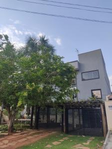 a house with a gate in front of a tree at jaó, mazzahome in Goiânia