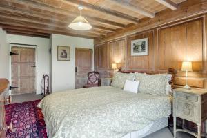 a bedroom with a large bed and wooden walls at 2 Bed in Hawes oc-c33371 in Hawes