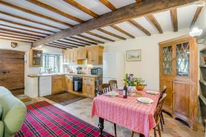 a kitchen with a table with a pink table cloth at 2 Bed in Hawes oc-c33371 in Hawes