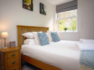a bedroom with a large white bed with a window at Rock Mill 1 Bed Apartment 36 in Stony Middleton