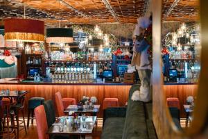 a restaurant with a bar with tables and chairs at Brogans Bar & Hotel in Trim