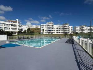 a swimming pool in front of some apartment buildings at Tropical Escape in Ceiba
