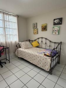 a bedroom with a bed and a tiled floor at Tropical Escape in Ceiba +15 photos