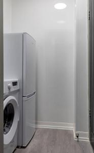 a washer and dryer in a white room at Caledonia Suite by The Wallace Monument in Stirling