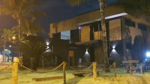 a building with a fence in front of it at night at jaó, mazzahome in Goiânia +3 photos