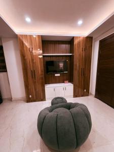 a living room with a large green ottoman at B&A Stays in Dehradun +3 photos