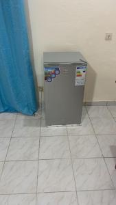 a small refrigerator sitting on the floor in a room at Bulle d'Or Serenity in Libreville