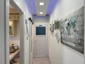 a hallway with a door and a map on the wall at 20 a Trieste in Trieste