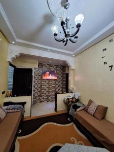 a living room with a couch and a fireplace at Nawal's guest house in Tadouart