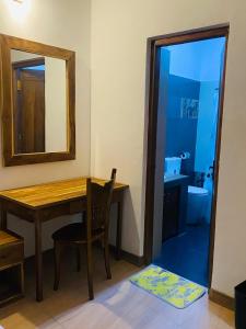 a room with a table and a mirror and a bathroom at New Arverne Villa Kandy in Kandy +18 photos