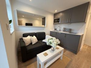 a small living room with a couch and a table at Rosewell Lower Dicker in Horsebridge