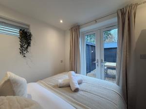 a bedroom with a bed with two towels on it at Rosewell Lower Dicker in Horsebridge